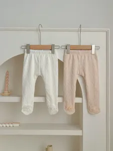 Cozy fleece-lined baby footed leggings with cute floral decoration, lovely detail view.