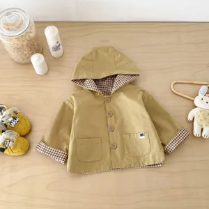 Detailed view of baby toddler hooded windbreaker jacket with plaid lining and cute buttons.