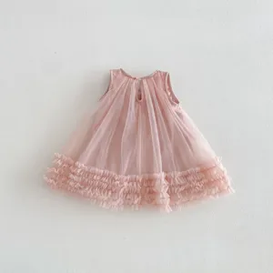 Close-up detail of girls pink sleeveless mesh ruffle dress, soft layered tulle fabric.