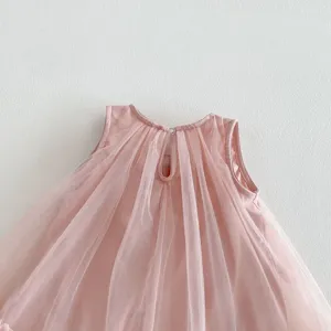 Pink girls sleeveless mesh dress detail, showing soft tulle fabric and back button closure.