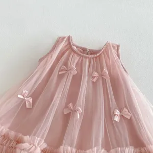 Pink toddler girl dress detail showing cute 3D bows, sheer mesh layers, and ruffles.