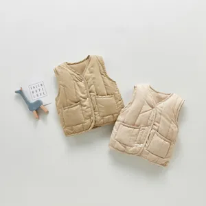 Children quilted cotton vest, cute baby winter outerwear, cozy pocket design, flat lay detail.