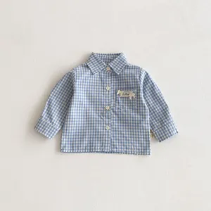 Camicia a maniche lunghe a quadri blu e bianco per bambina con taschino frontale chic.