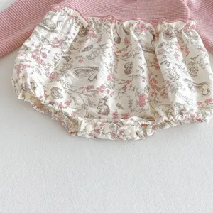 Infant baby girl long sleeve floral romper detail shot, cute pink waffle knit bodysuit.