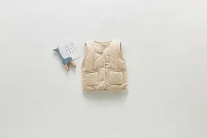 Detailed view of beige quilted baby vest with snap buttons and front pockets for winter.