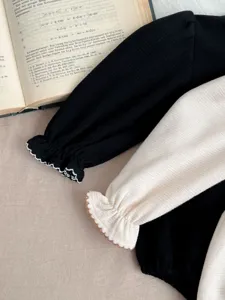 Infant baby romper detail shot, long sleeve bodysuit with delicate lace cuffs, cute baby clothes