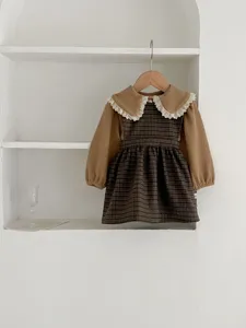 Toddler baby girl sweet plaid dress set with lace collar hanging on minimal white shelf detail.
