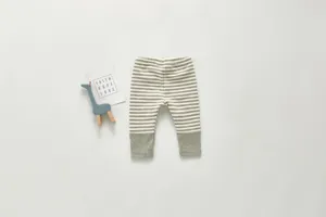 Detailed view of infant striped cotton pants, soft knit long trousers with ribbed cuffs.
