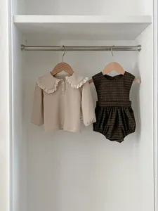 Infant baby girls long sleeve ruffled collar top and plaid sleeveless romper detail view.
