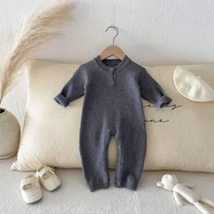 Baby knitted romper with raglan sleeves and buttons, cozy long-sleeved design perfect for autumn.
