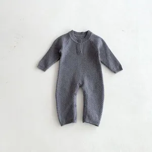 Baby knitted romper with raglan long sleeves, solid charcoal grey infant crawlers detail.