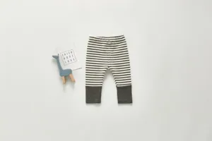 Infant striped leggings detail, soft cotton knit fabric, cozy winter baby pants close-up view.