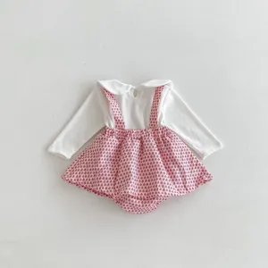 Infant baby girl autumn long sleeve white top with pink printed suspender romper detail view.