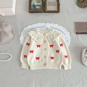 Cute baby knit cardigan with ruffles and red bows, sweet infant sweater for little girls.