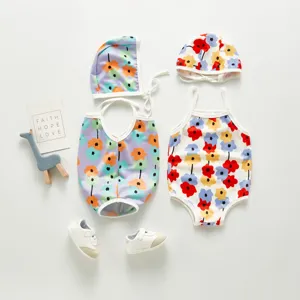 Detailed view of cute toddler baby girls floral one-piece swimsuit with matching swim cap set.