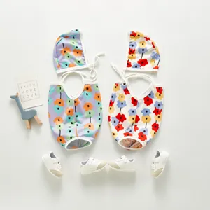 Detailed shot of toddler floral swimsuit set with matching cap and shoes, vibrant summer style.