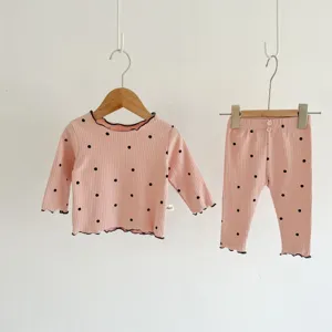 Infant ribbed polka dot long sleeve top and pants detail view, pink homewear set with lettuce edge.
