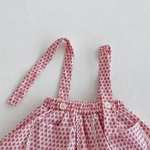 Infant baby girl cute floral strap romper dress detailed view, comfortable cotton fabric.