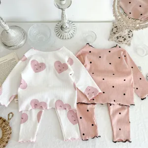Infant cotton rib pajama set detail, cute heart and dot prints, cozy long-sleeve style.
