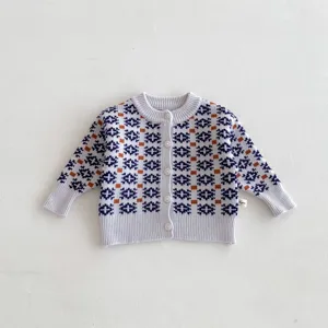 Infant knit cardigan sweater detail, cute geometric pattern, soft cotton fabric for baby.