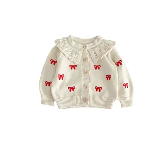 Cute baby girl knit cardigan with red bow embroidery and ruffled collar. Soft cotton sweater.