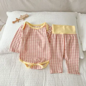 Primo piano dettagliato del body a quadri rosa e pantaloni a vita alta per neonati.