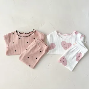 Infant ribbed cotton long sleeve pajama set with cute ruffles and heart print details for baby girls