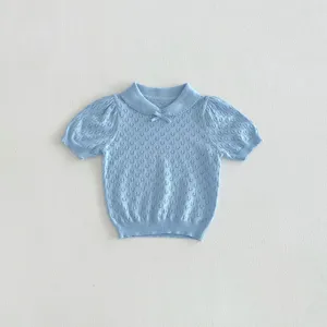 Detailed view of baby girl short sleeve knit top, hollow-out texture and cute collar bow.