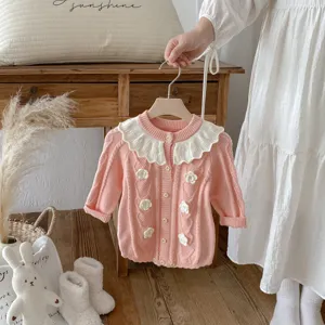 Infant knit cardigan with lotus leaf collar and floral accents for baby girls winter.
