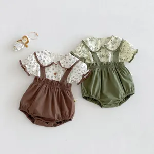 Detail view of baby summer floral peter pan collar short sleeve top and suspender shorts 2-piece set.