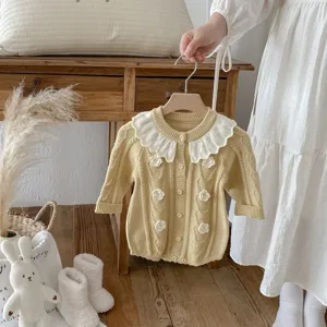 Infant baby knit romper detail, featuring white lotus leaf collar and hand-crocheted flowers.