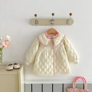 Detailed view of cute toddler girls quilted winter coat featuring sweet pink ruffle collar.