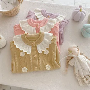 Infant knit cardigan detail showing cute lotus leaf collar, hand-crocheted flowers, and cozy soft fabric.