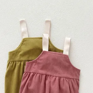 Corduroy baby overalls detail view, soft fabric texture, cute strap design for infant.