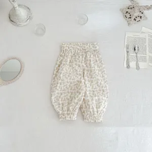 Detailed shot of floral baby bloomers featuring elastic high waist and cute gathered cuffs.