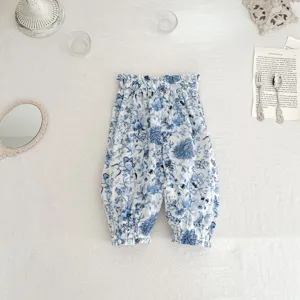 Baby floral bloomers detail, blue and white print fabric with elastic gathered cuffs and waistband.