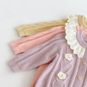 Cute baby knit cardigan with ruffle collar and handmade crochet flowers, soft autumn winter clothes.