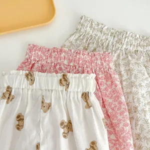 Detail shot of baby summer anti-mosquito pants featuring cute bear and floral prints.
