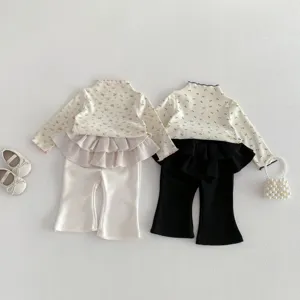 Toddler girl two-piece flare pants set with floral long sleeve top and ruffle skirt detail.
