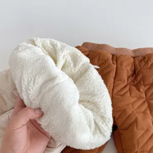 Gedetailleerde close-up van zachte fleecovoering en gewatteerde winterstof voor baby's.