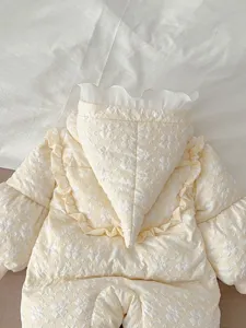 Detailed view of infant winter quilted down romper with cute pointy hood and floral texture.