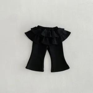 Toddler girls black flare skirt pants detail, cute ruffles waist design for spring daily wear.