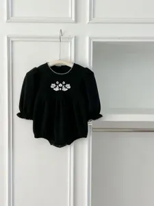 Infant baby black floral embroidered romper with cute puff sleeves and delicate lace trim.