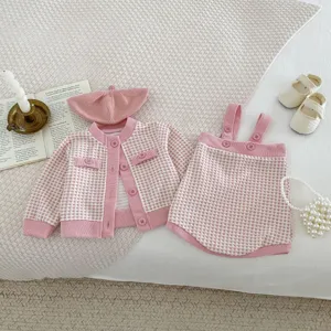 Cute infant baby girl pink check cardigan suspender shorts beret set detail view.