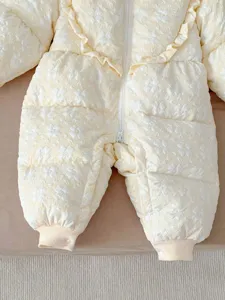 Infant winter down snowsuit detail shot featuring cute floral jacquard pattern and front zipper.