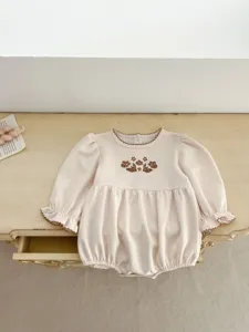 Cute newborn baby girl long sleeve romper with sweet floral embroidery and delicate ruffles.