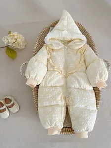 Detailed view of baby winter hooded down jumpsuit with cute floral embossing in soft yellow.