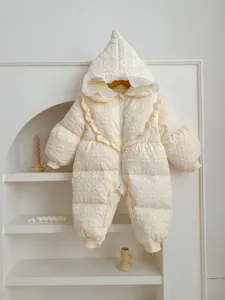 Infant winter down romper detail, cute hooded design with cute ruffles and soft quilted texture.