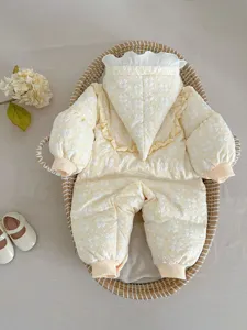 Infant winter down romper detailed close-up, cute floral quilted design with pointy hood.