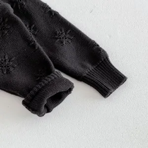 Kleinkind Strickjacke Ärmel Detail, weicher dunkelgrau Stoff mit süßen bestickten Sternen.